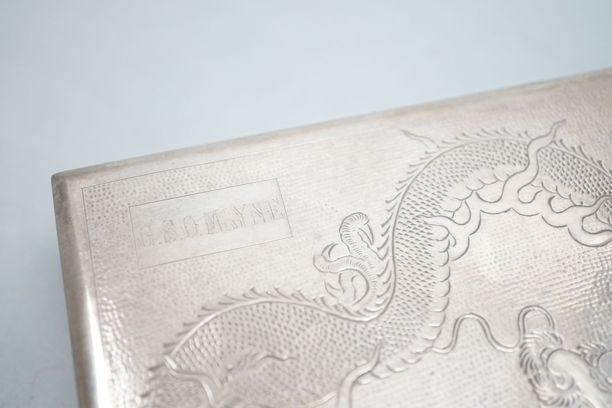 A Chinese Export sterling mounted cigarette box, Lee Yee Hing, engraved with dragon, 17.3cm, gross 18.5oz.